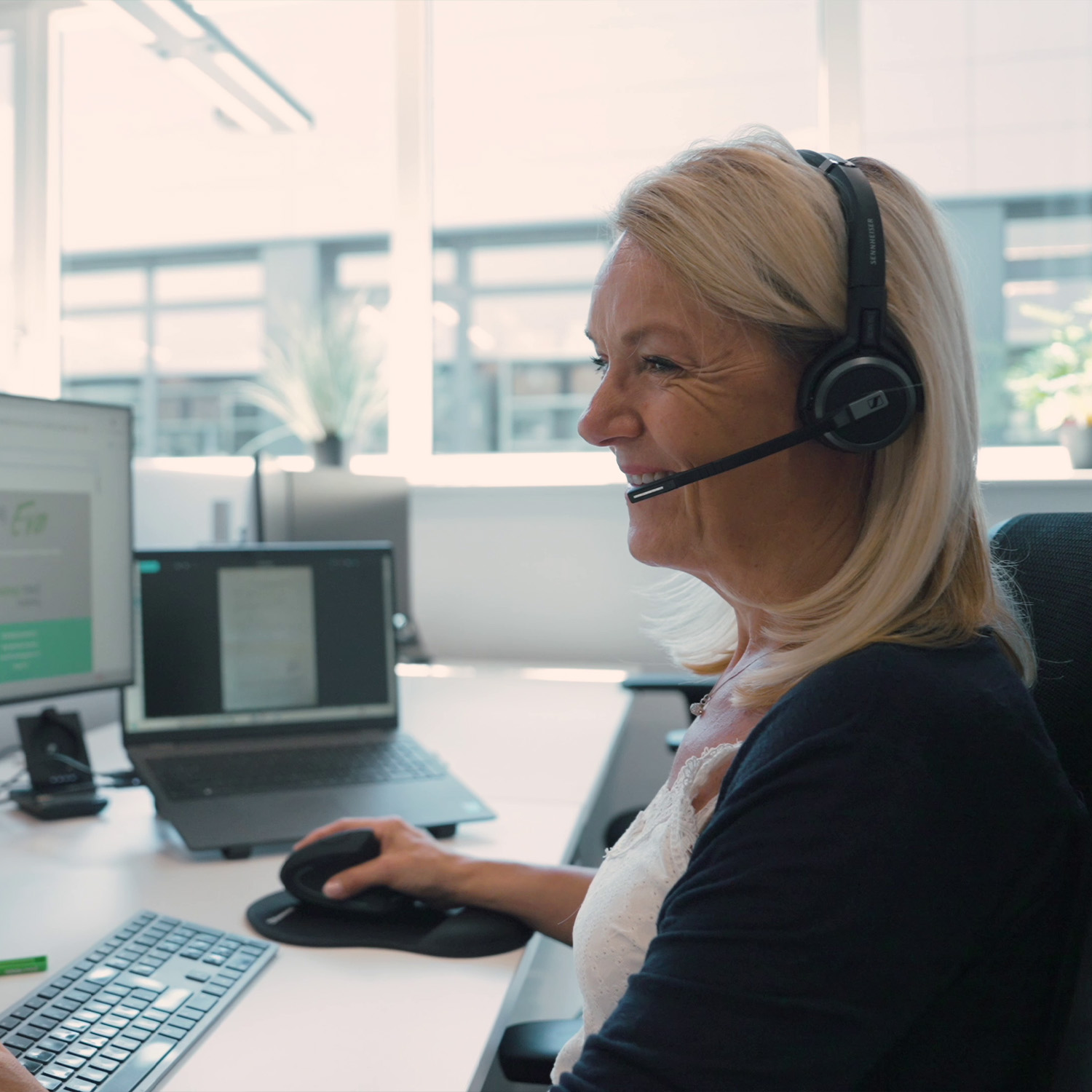 Eine Mitarbeiterin von nova:med beantwortet per Headset eine Kundenanfrage